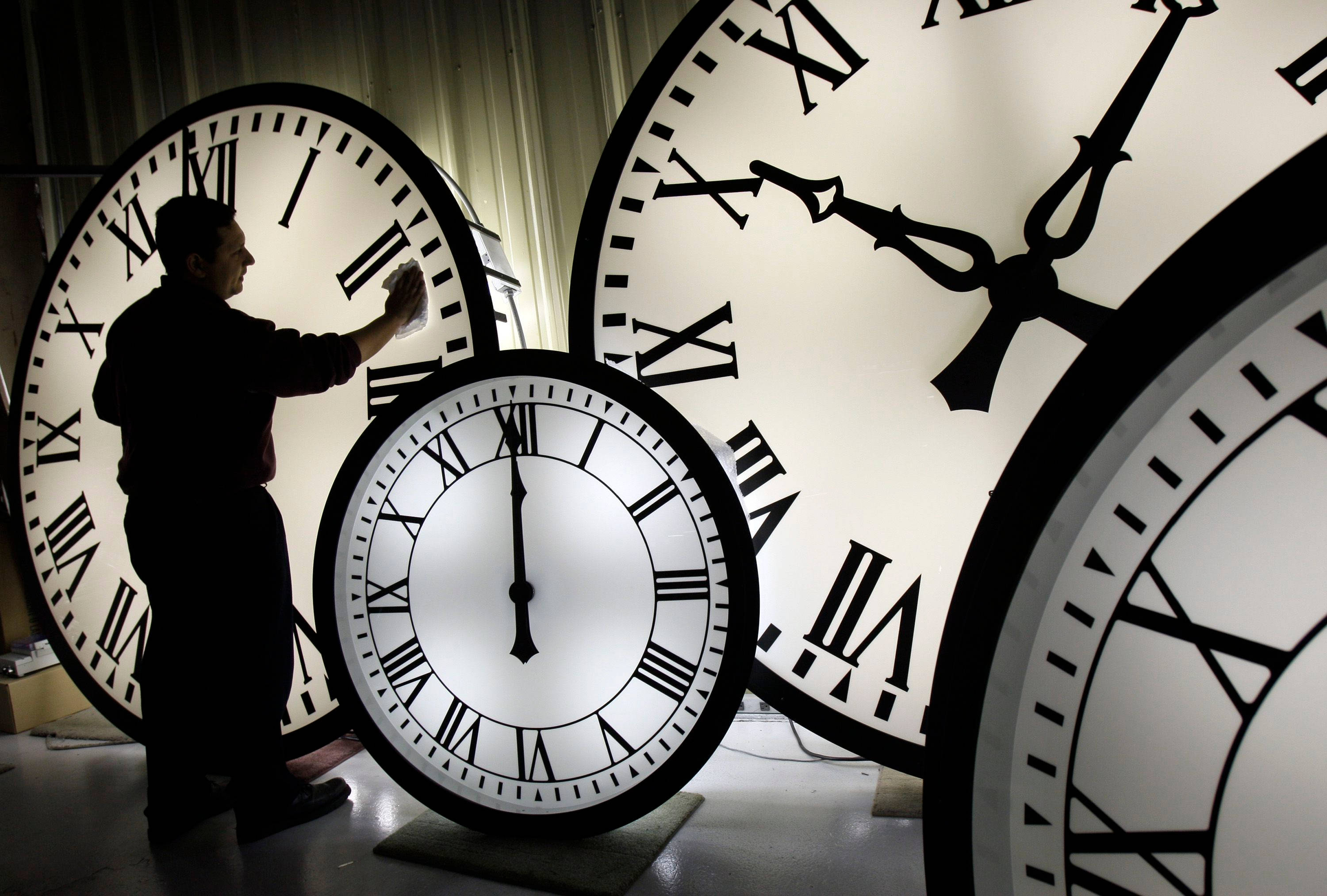 Man Cleaning Large Tower Clocks Wallpaper