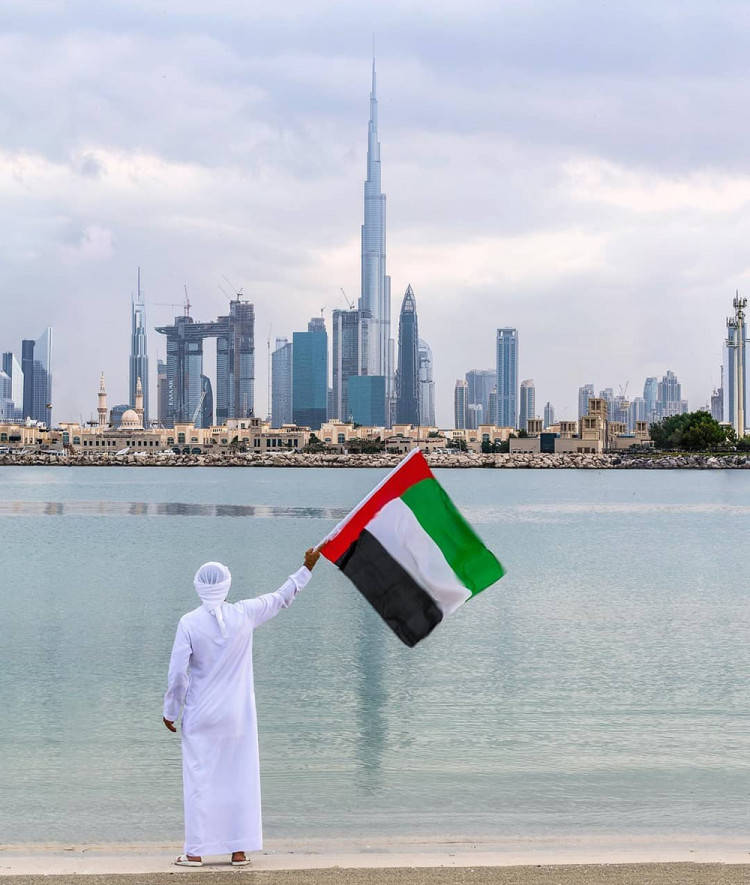 Man Holding Uae Flag Wallpaper