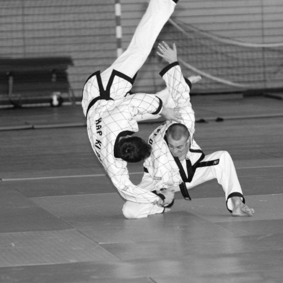 Master In Action: Demonstrating A Hapkido Hand Throw Technique Wallpaper