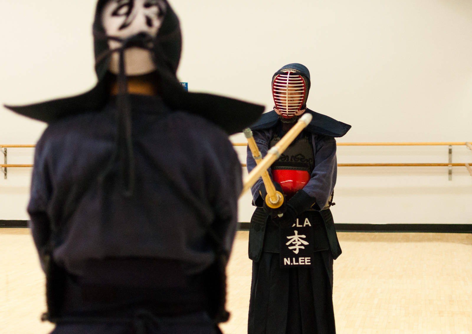 Members Of Ucla's Kendo Club In Action At A Tournament Wallpaper