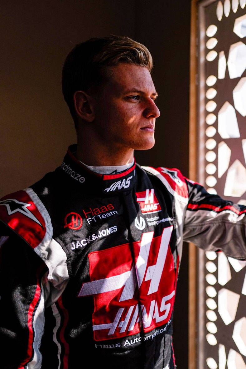 Mick Schumacher Looking Out The Window Wallpaper