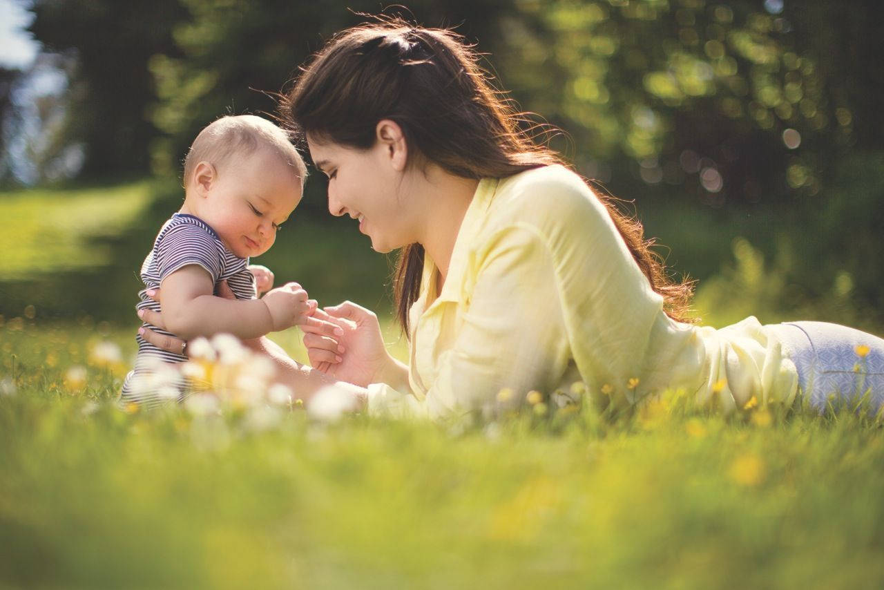 Mom And Son On Grass Wallpaper