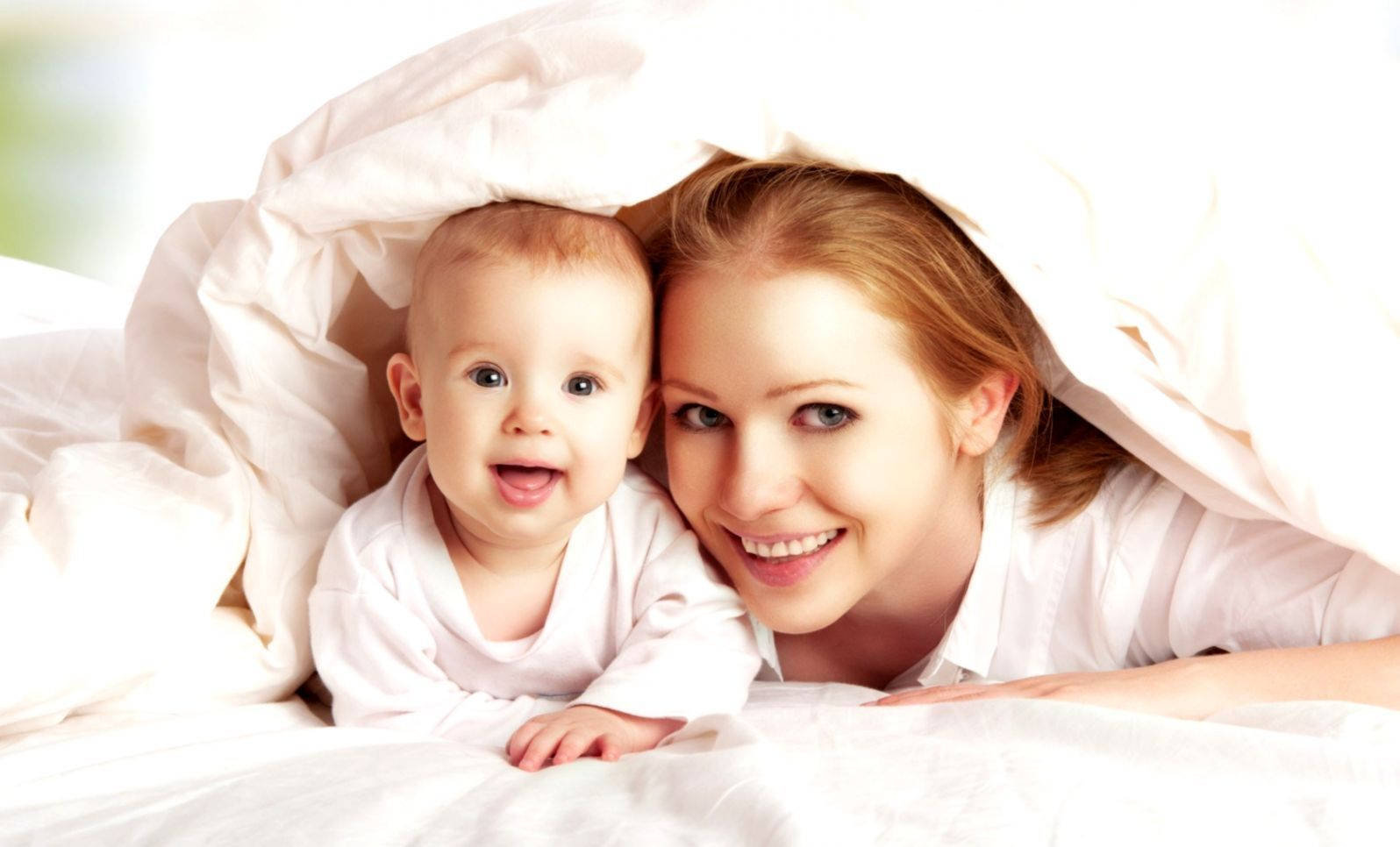 Mom And Son Under Blanket Wallpaper