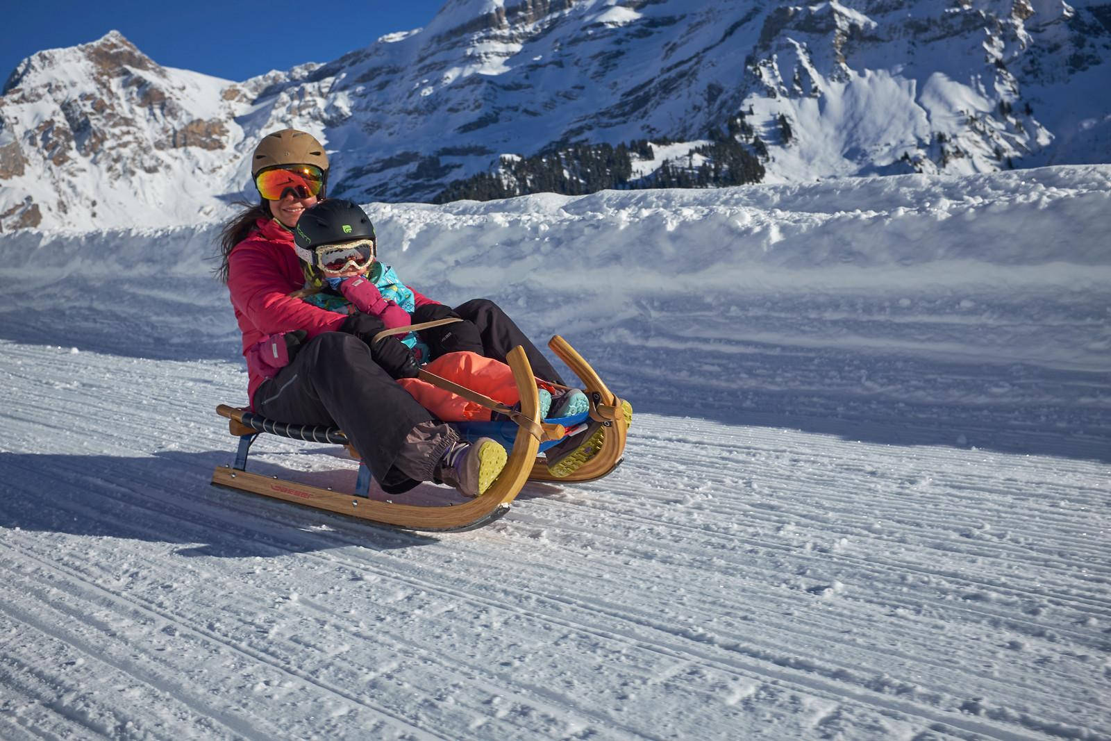 Mother And Baby Sledding Wallpaper