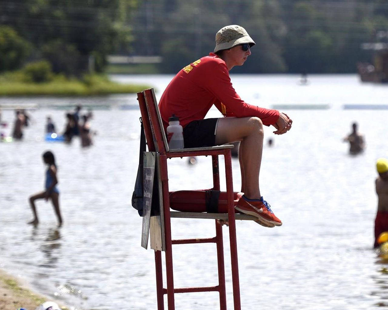 On Duty Lifeguard Sitting On Chair Wallpaper