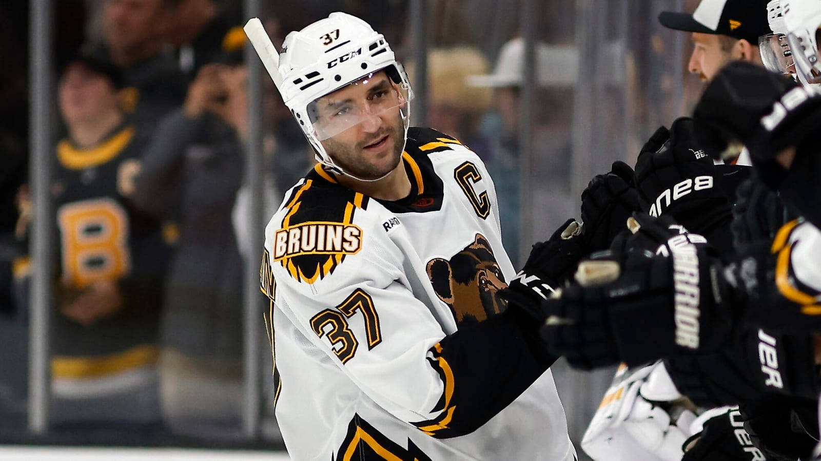 Patrice Bergeron White Uniform With Teammates Wallpaper