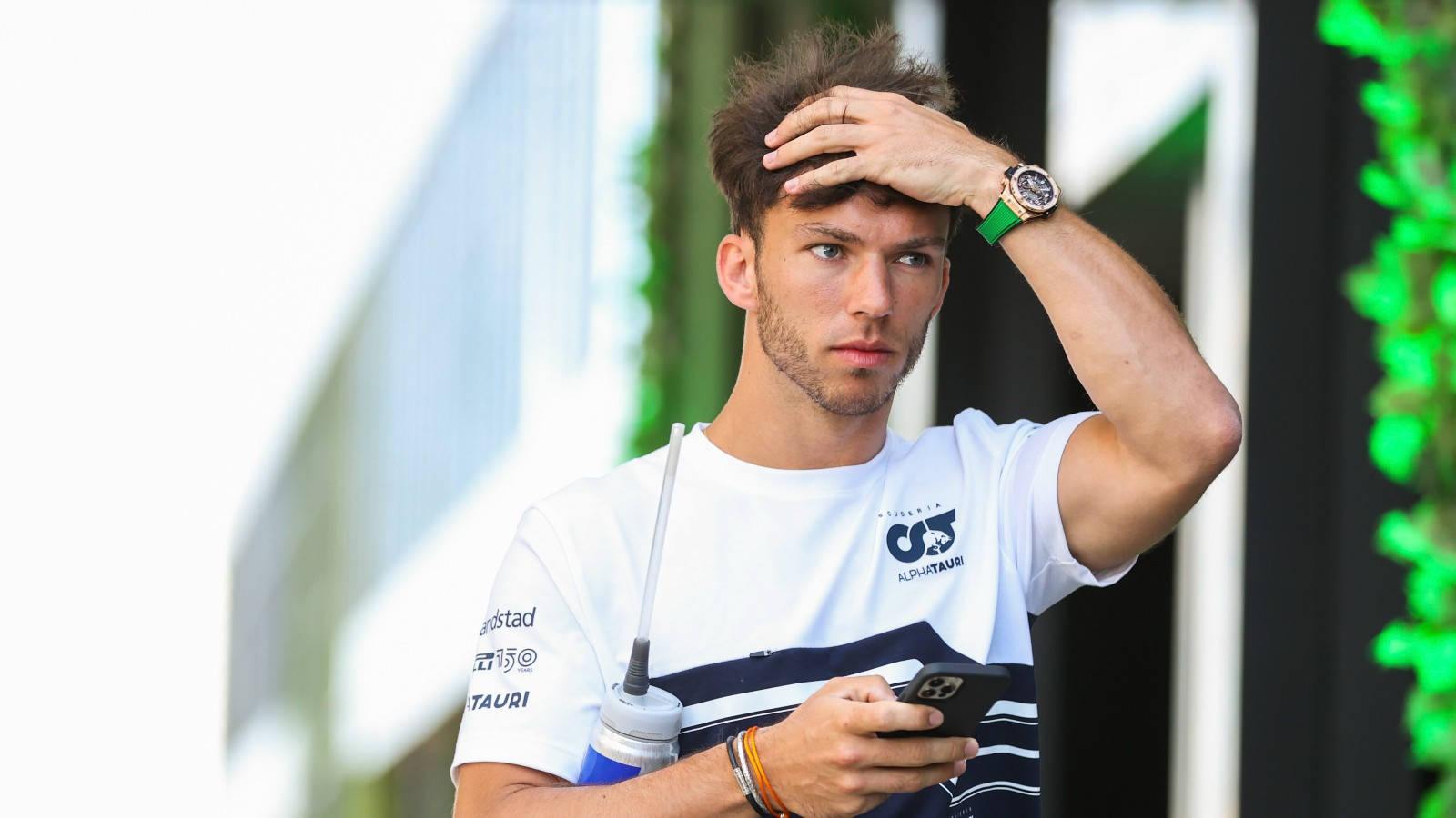 Pierre Gasly Adjusting His Helmet With Full Focus Wallpaper