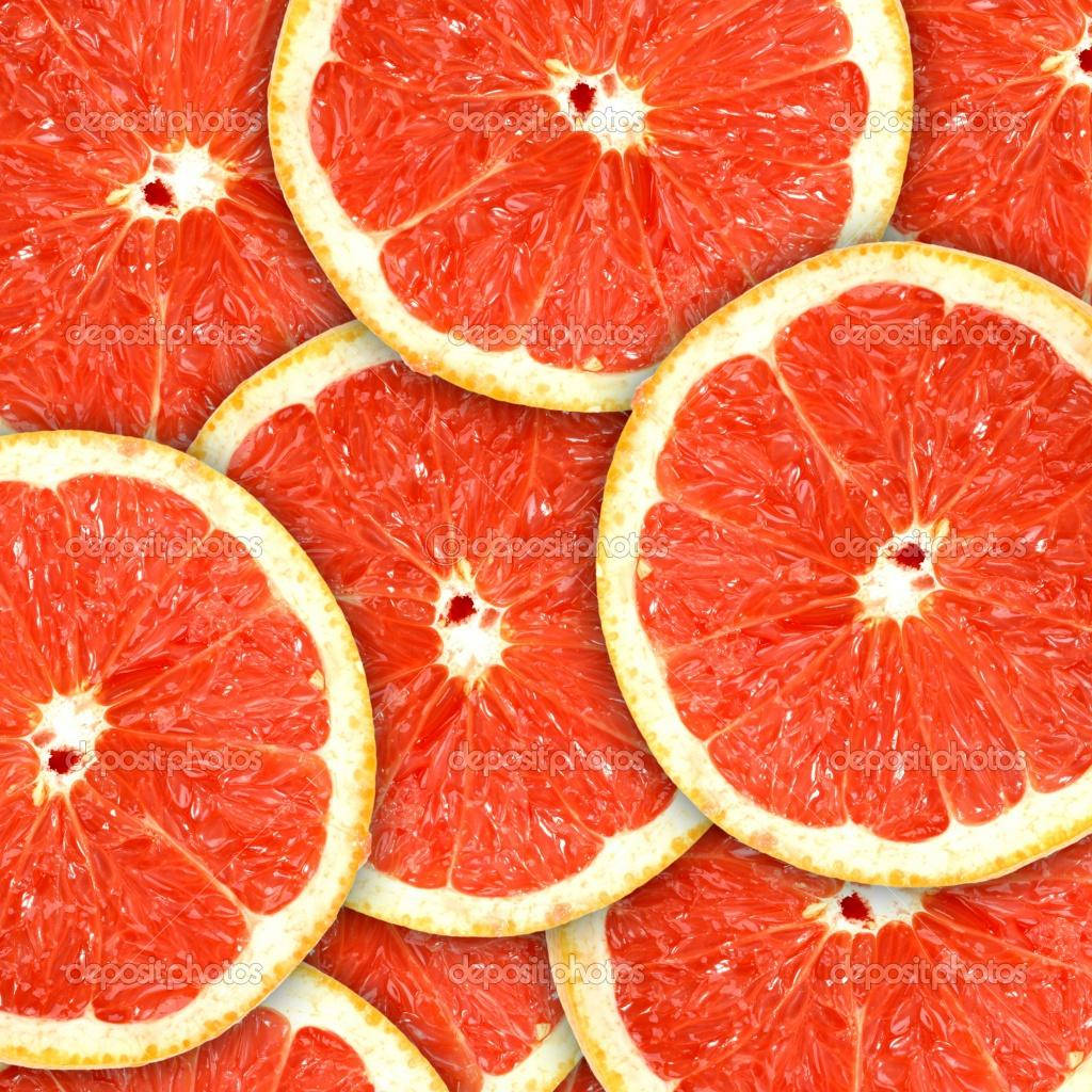 Pile Of Sliced Tropical Grapefruits Wallpaper