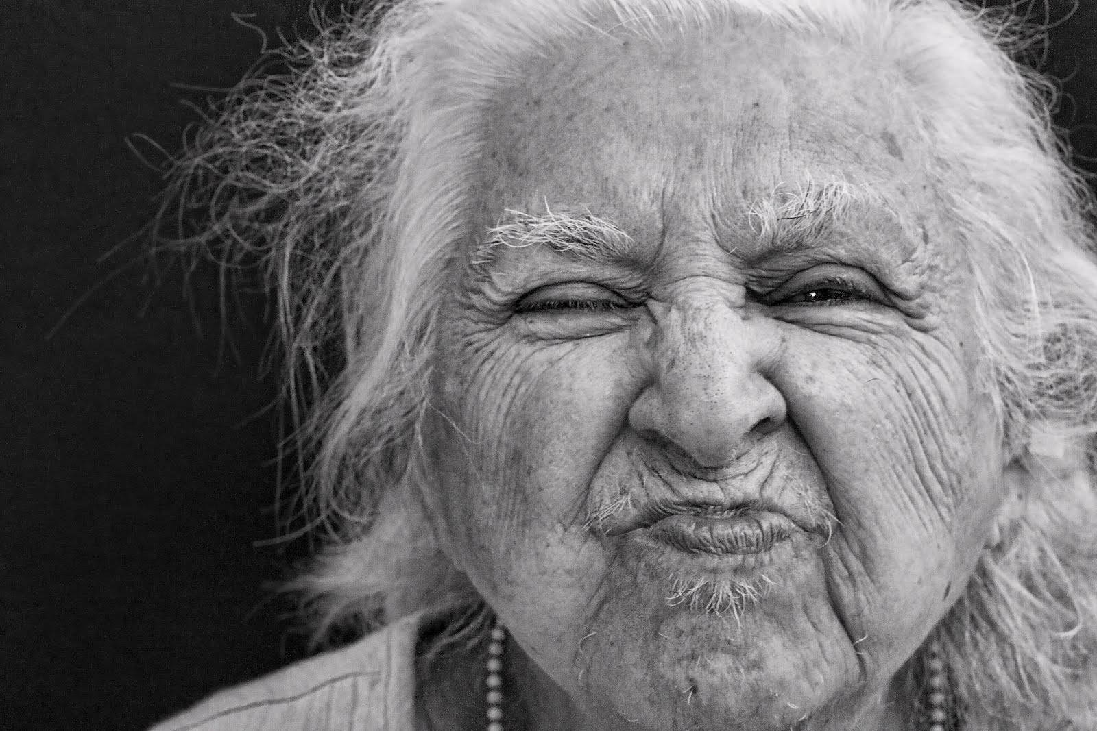 Portrait Of A Radiant Elderly Woman With Pouty Lips Wallpaper