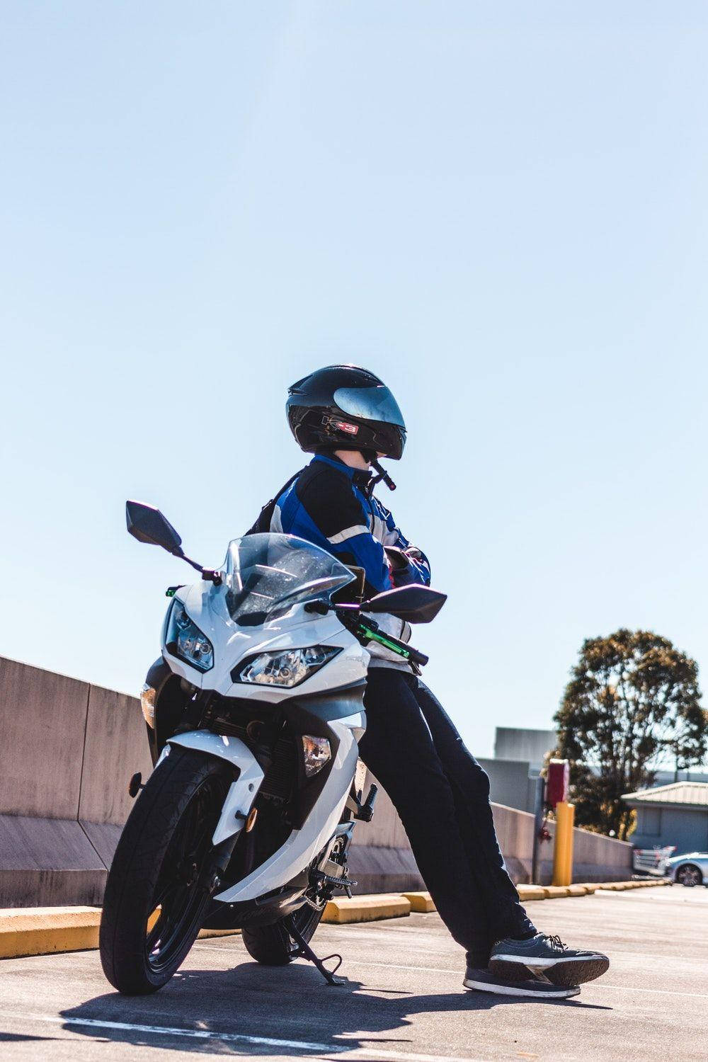 Rider Sitting On White Bikes Wallpaper