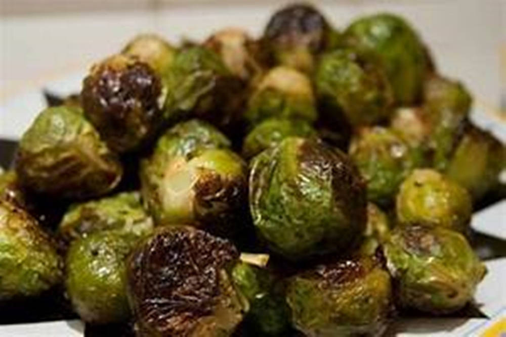 Roasted Brussels Sprouts On A White Plate Wallpaper