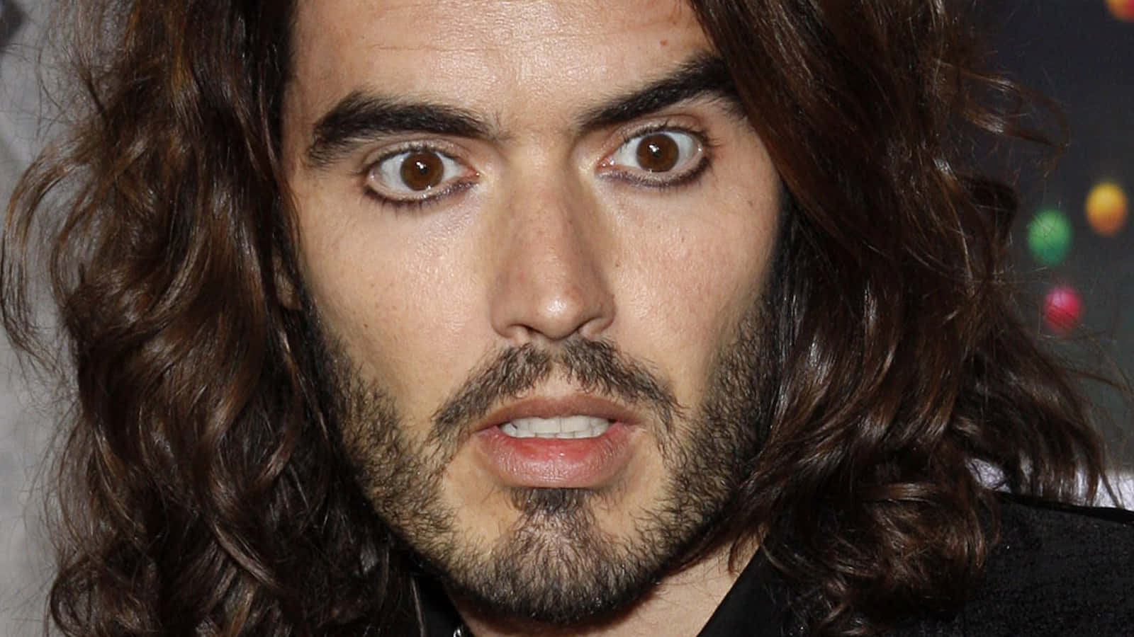 Russell Brand In His Signature Style Wallpaper