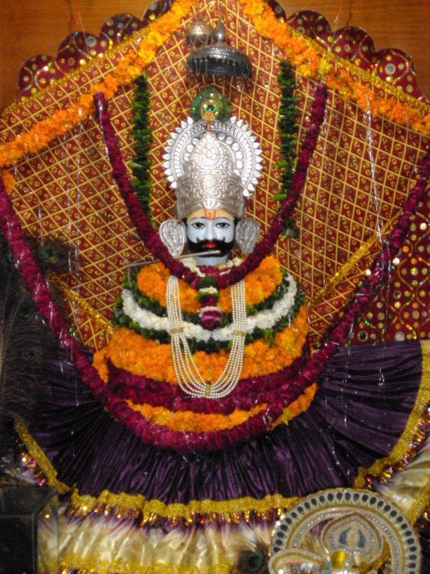 Shyam Baba Statue With Colorful Garlands Wallpaper