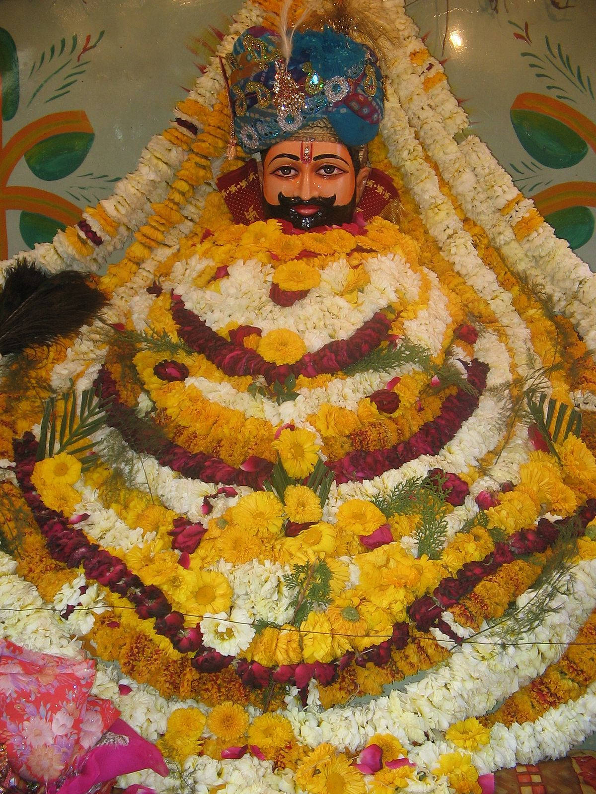 Shyam Baba Statue With Yellow Garlands Wallpaper