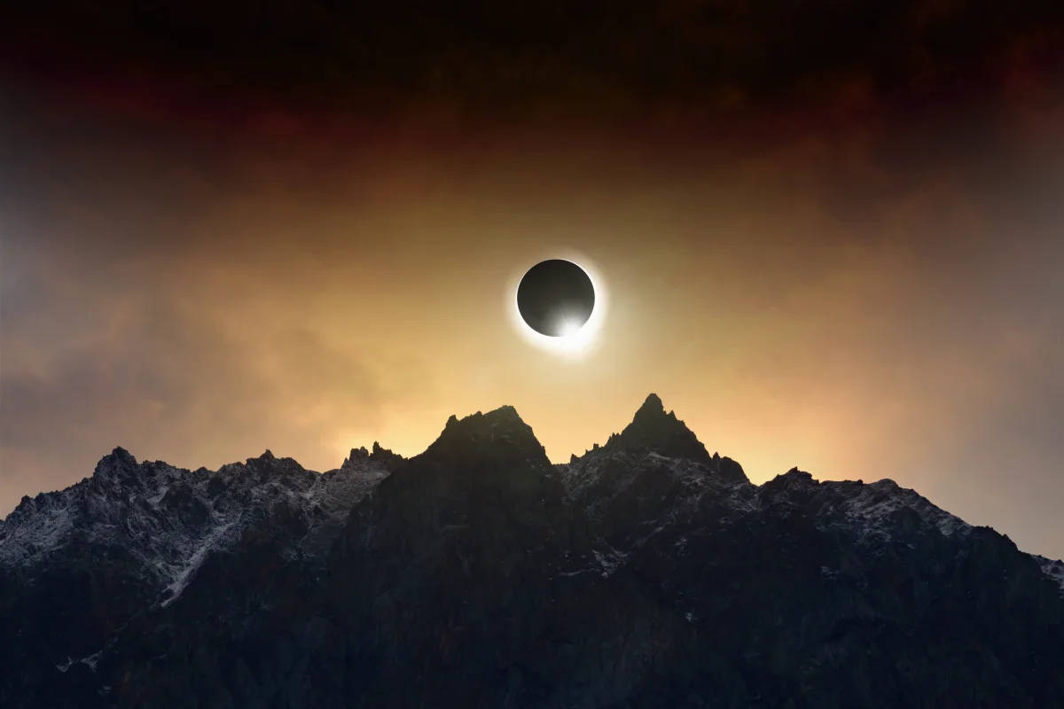 Solar Eclipse On Cloudy Mountaintop Wallpaper