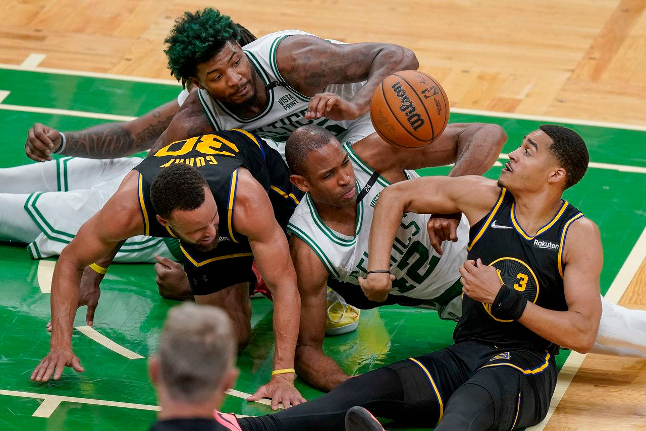 Steph Curry On The Floor With Other Players Wallpaper