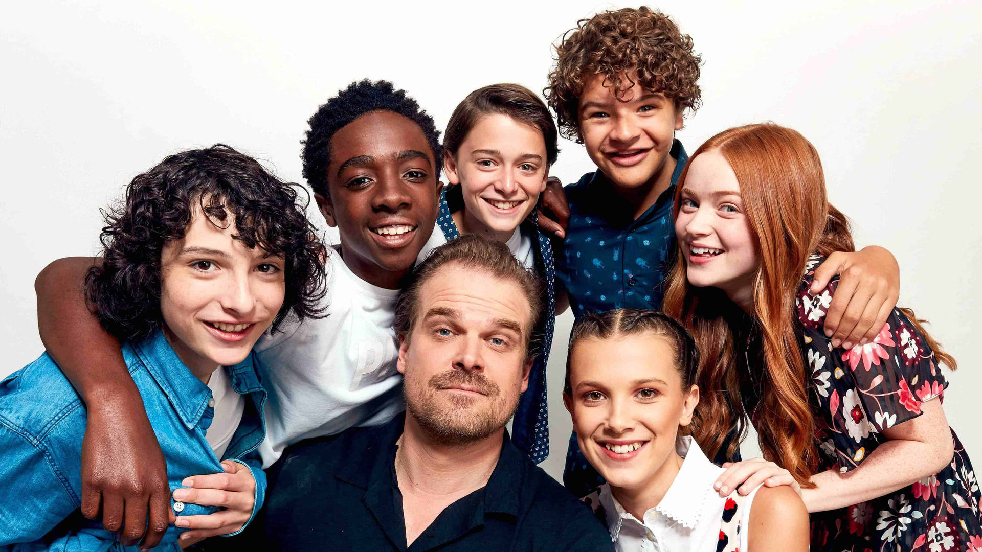 Stranger Things Cast Smiling White Background Wallpaper