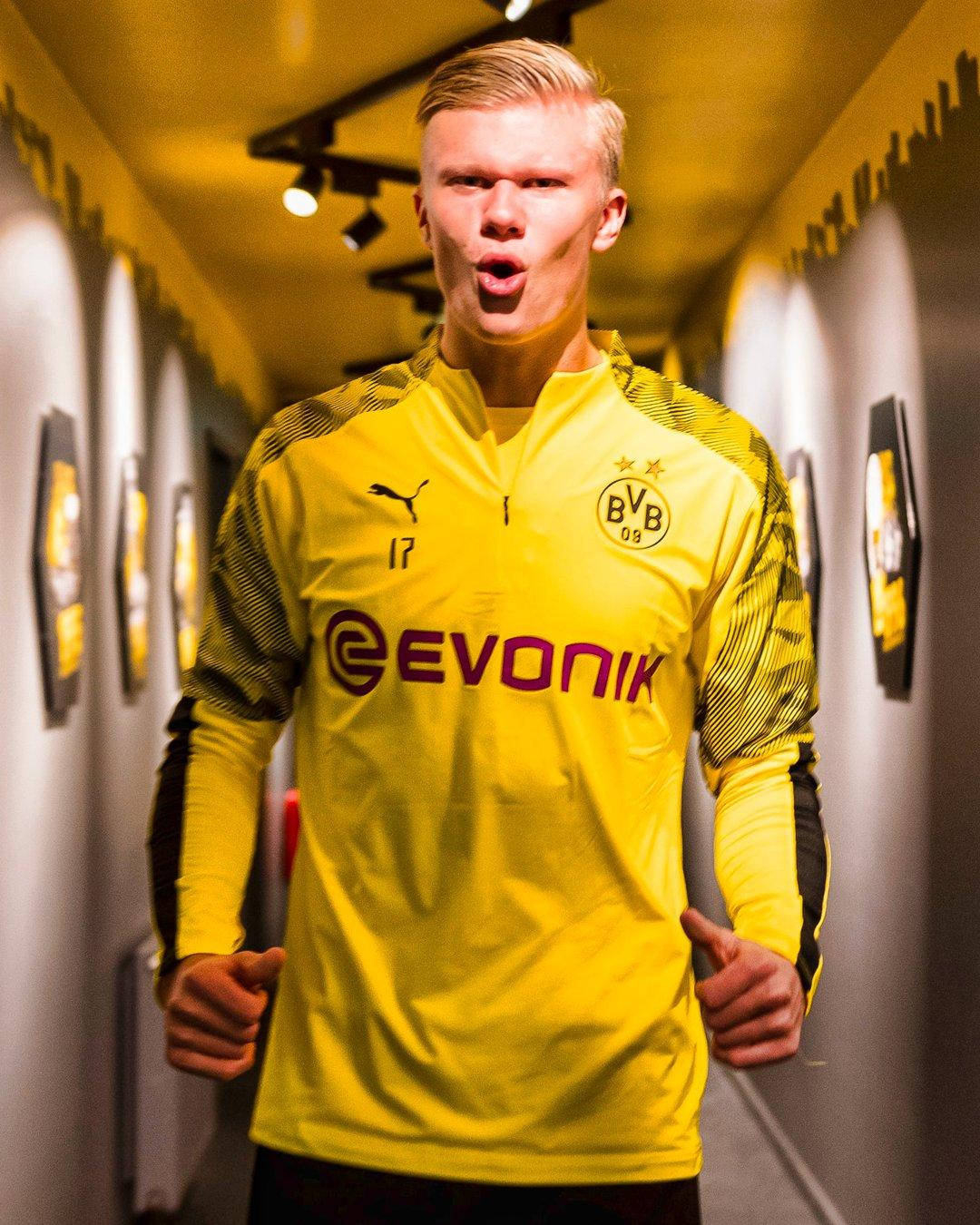 Striker Haaland Wearing Yellow Bvb Jersey Wallpaper