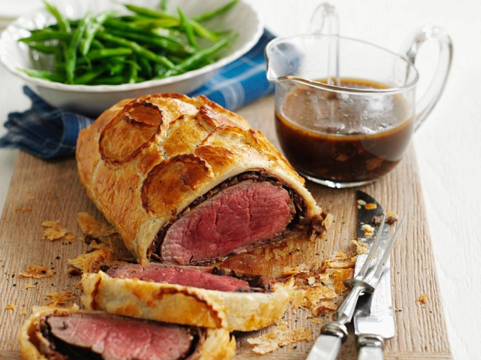 Succulent Beef Wellington Served With Asparagus And Sauce Wallpaper