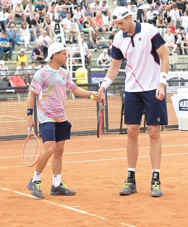 Tennis Superstars John Isner And Diego Schwartzman In An Intense Match Wallpaper