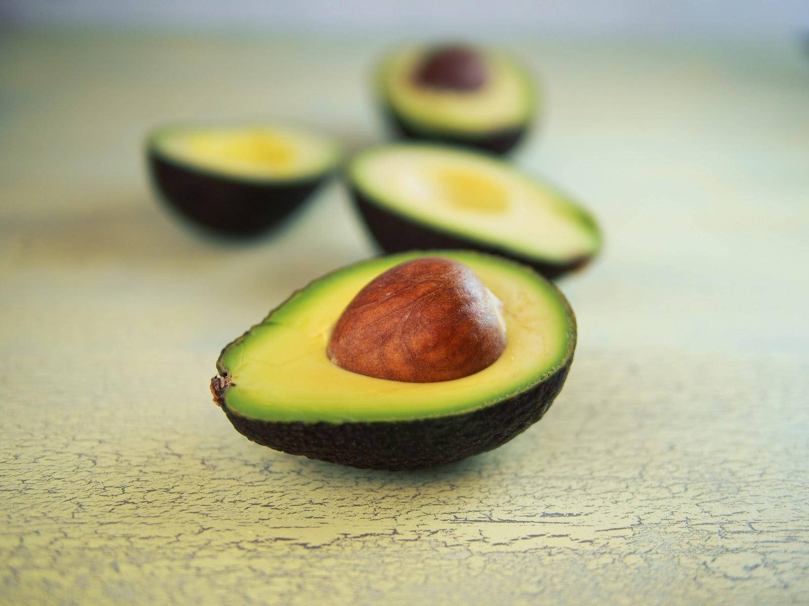 Tiny Avocado Fruits Cut In Halves Wallpaper