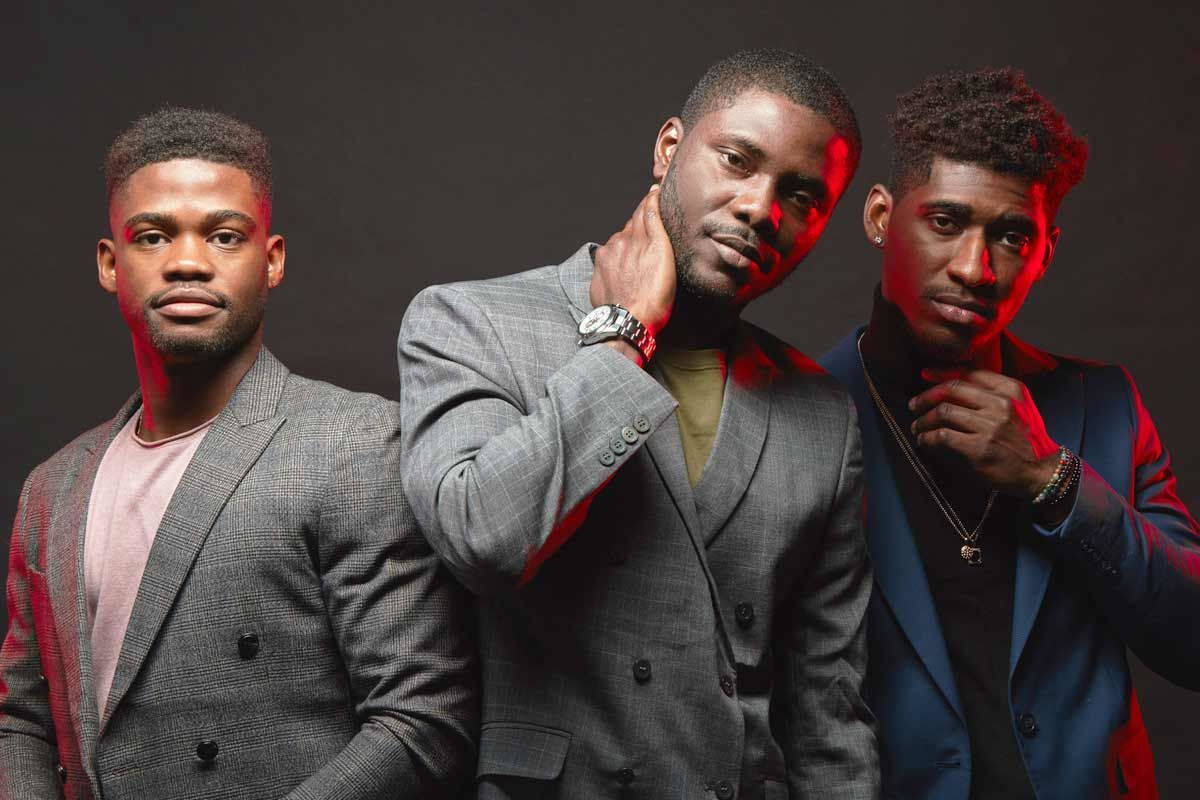 Trio Of Confidence: Distinguished Black Men In Modern Fashion Wallpaper