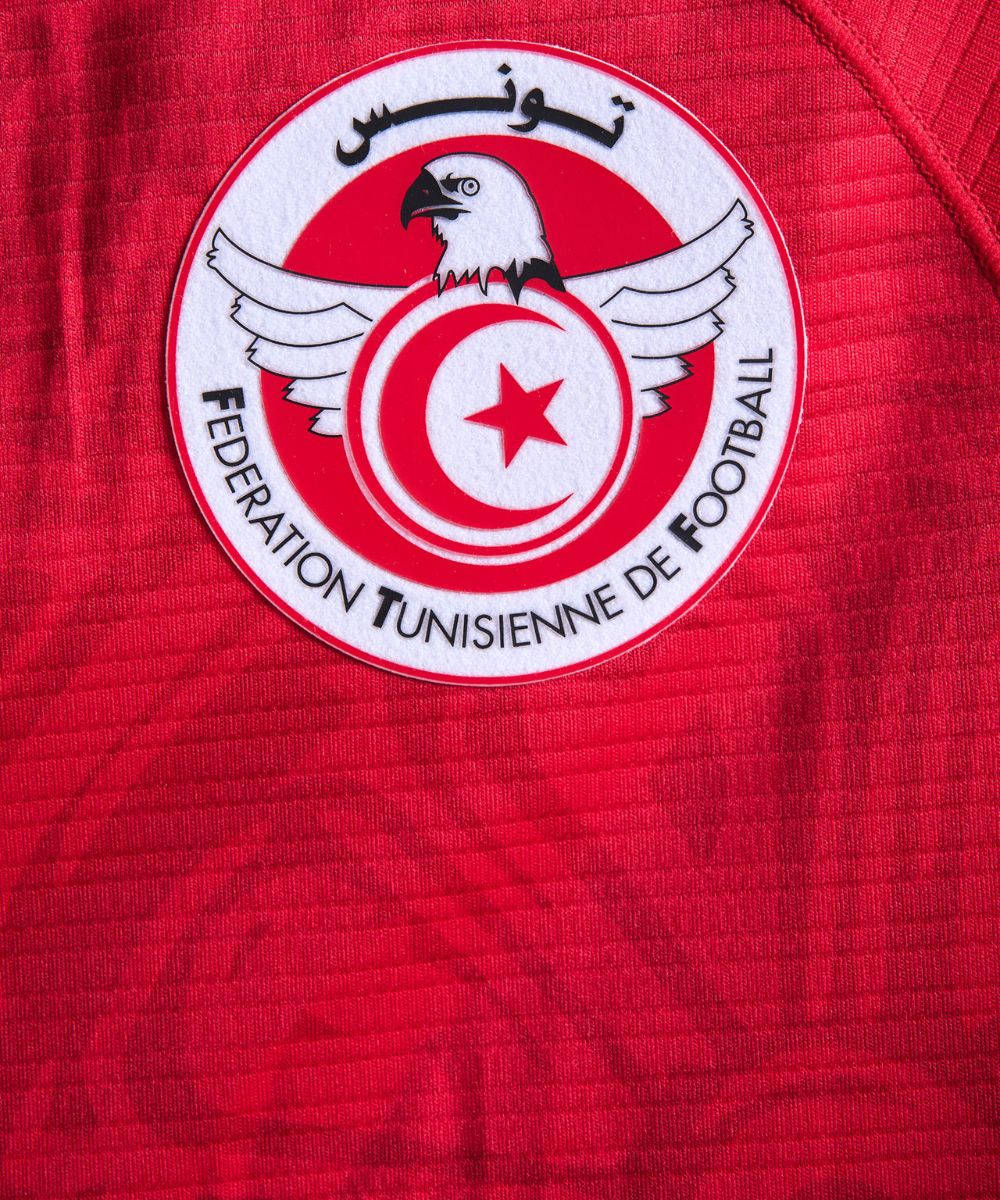 Tunisia National Football Team Logo In Red Jersey Wallpaper