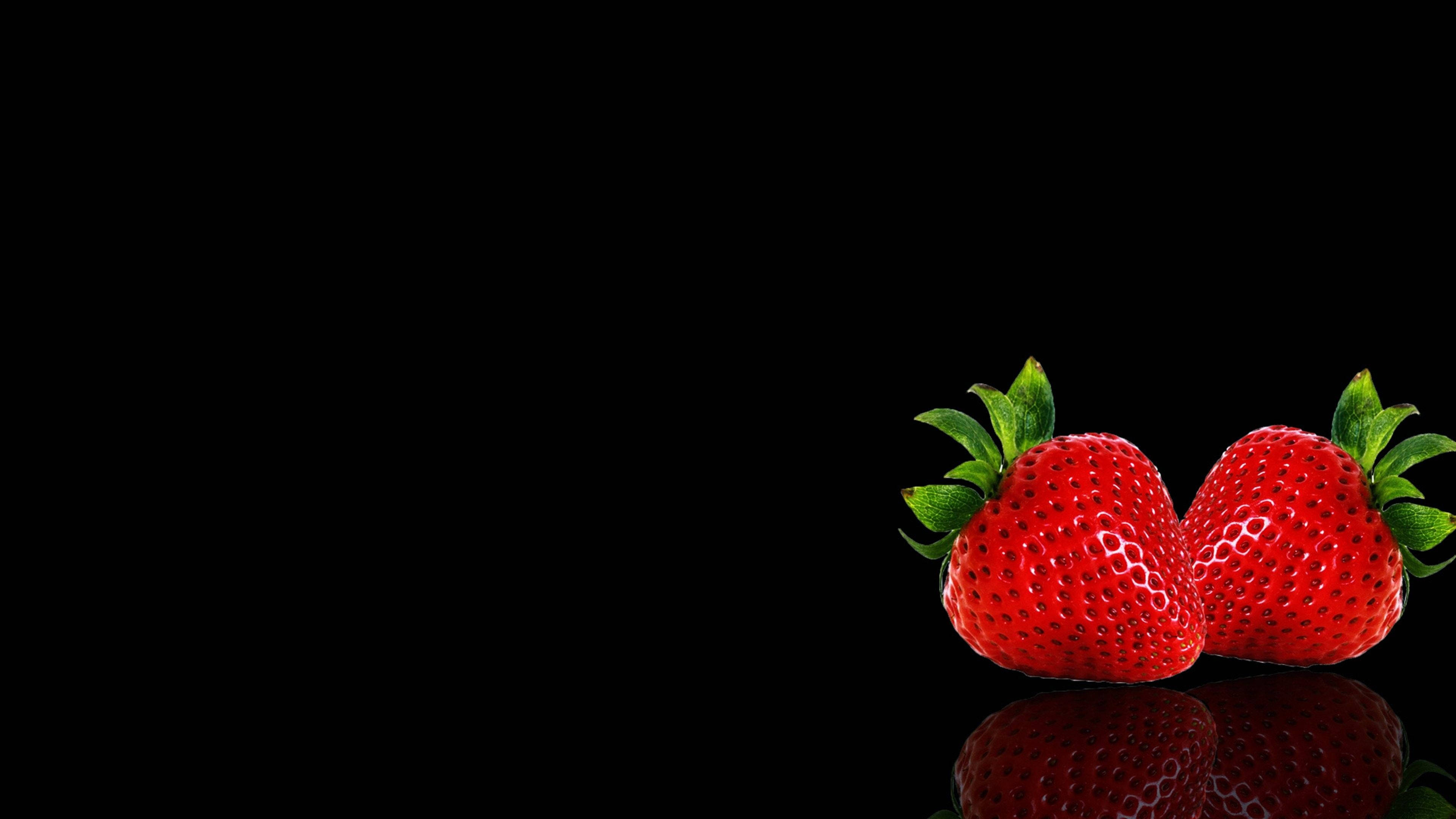 Vibrant Strawberry Twins On A Black Backdrop Wallpaper