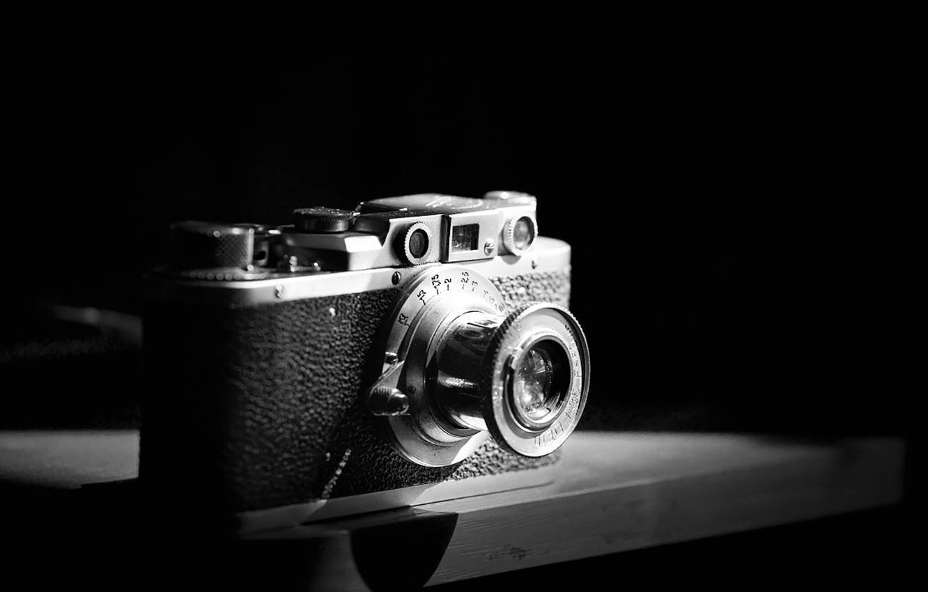 Vintage Camera - A Classic Journey Through Time In Black And White Wallpaper