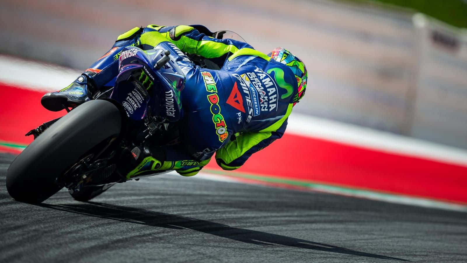 Vr46 Racer Navigates A Curve On The Track Wallpaper