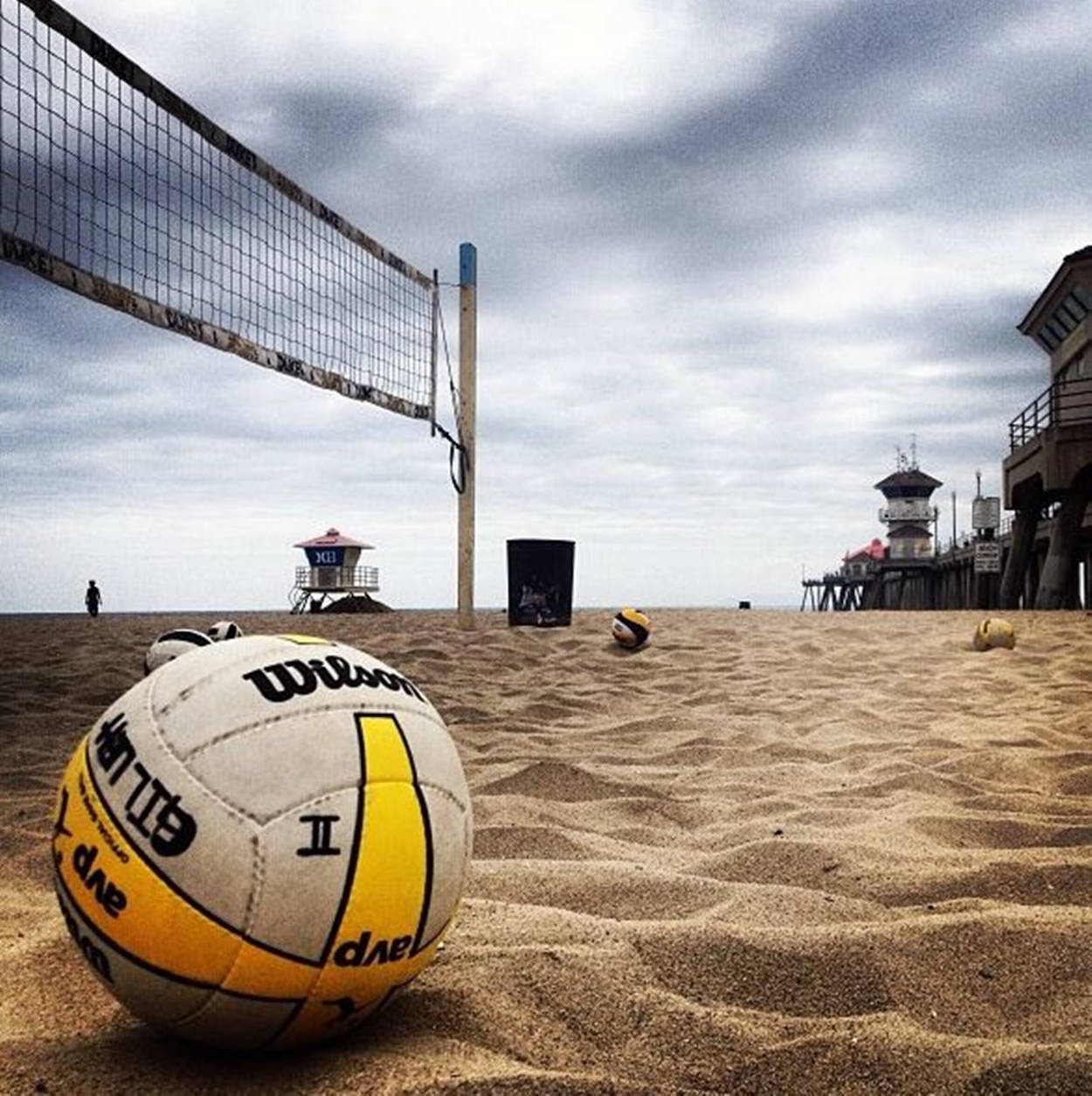 Wilson Beach Volleyball Under Gray Clouds Wallpaper