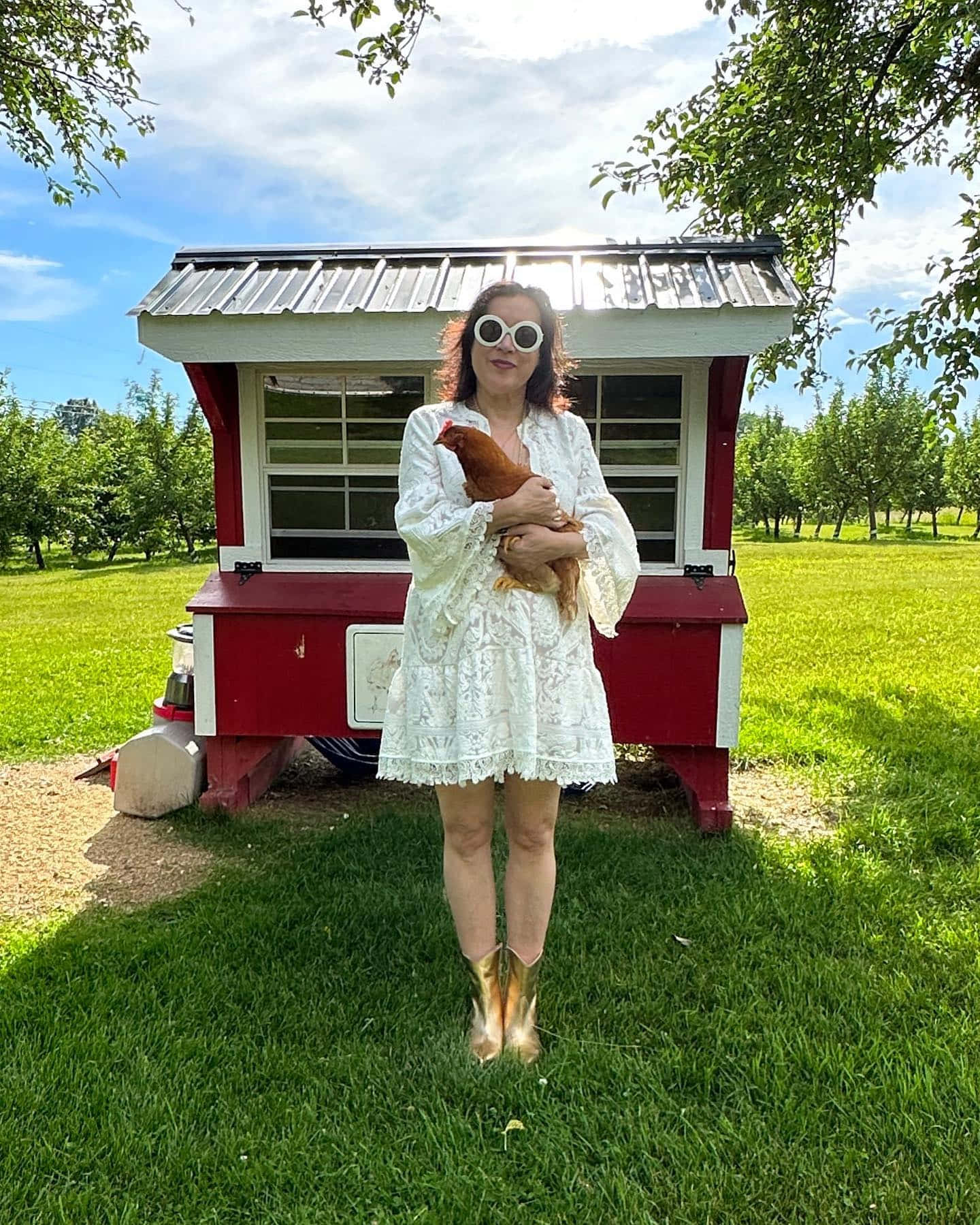 Woman Holding Chickenat Red Henhouse Wallpaper