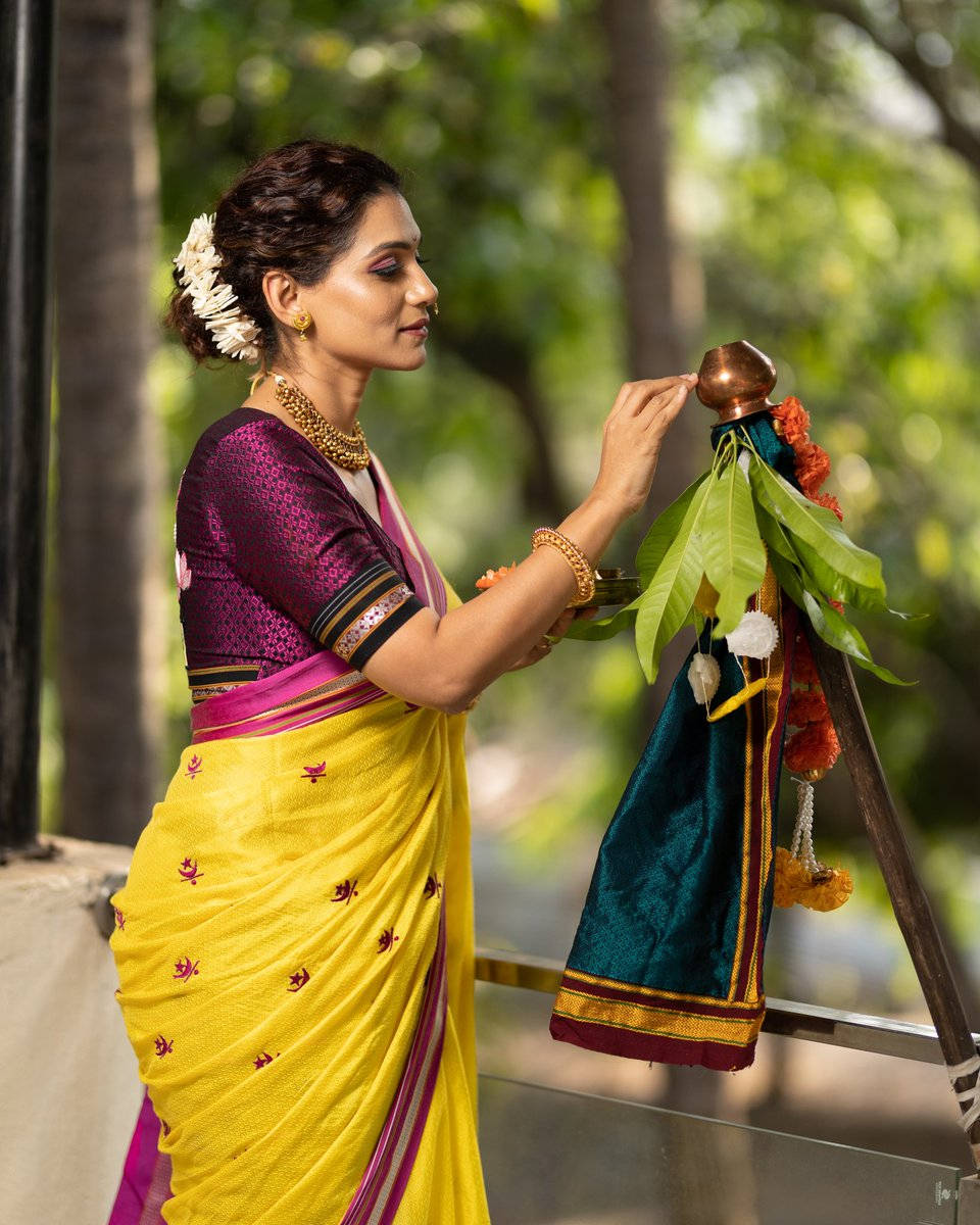 Woman Touching A Gudi Padwa Showpiece Wallpaper