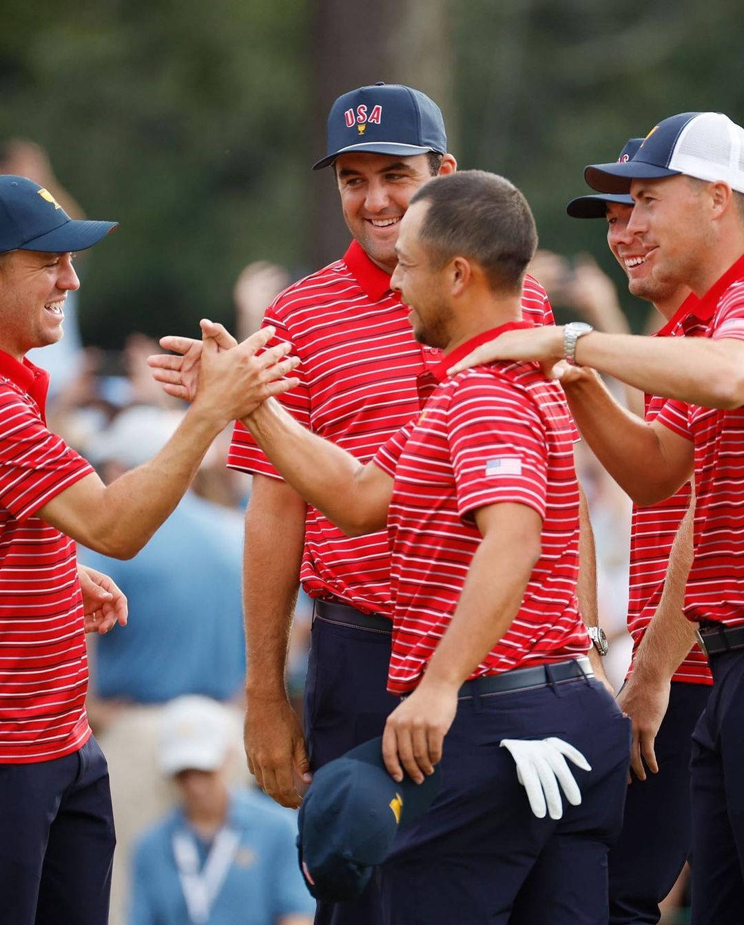 Xander Schauffele Surrounded By Golfers Wallpaper