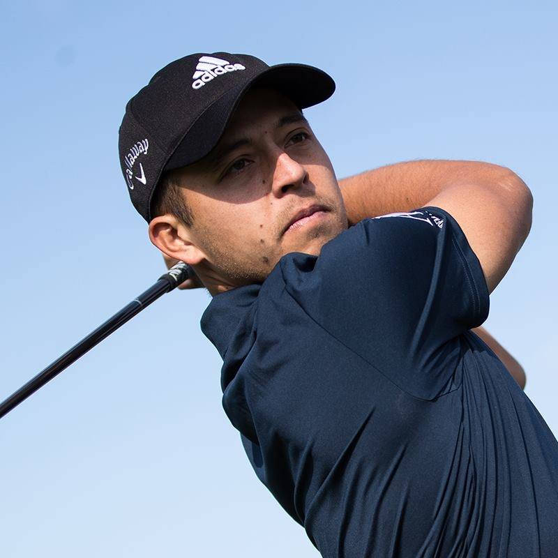 Xander Schauffele Swinging A Golf Club Wallpaper