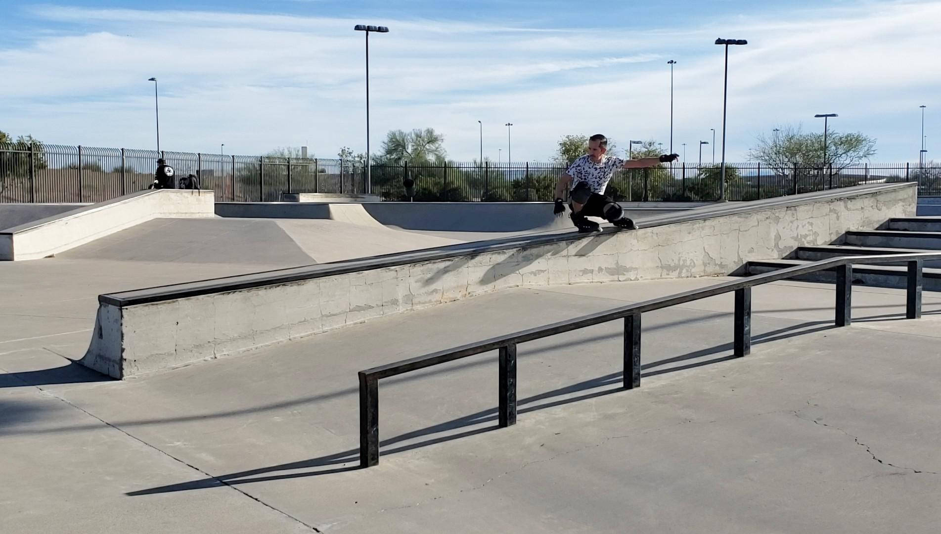 Youthful Enthusiasm: Boy Rollerblading At Skate Park Wallpaper