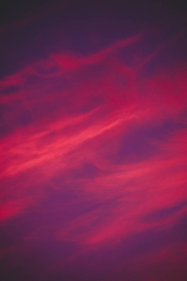 A Beautiful, Dark Pink Aesthetic Sunset Above The Clouds Wallpaper