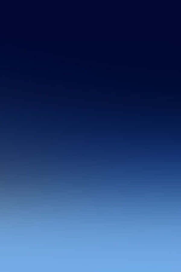 A Beautiful Gradient Of Dark Blues Set Against The Stars. Wallpaper