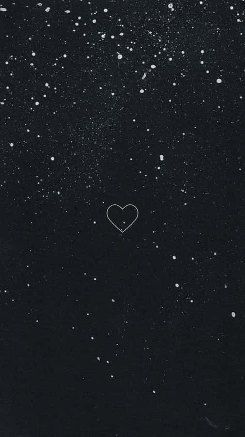 A Black Background With A Heart In The Sky Wallpaper