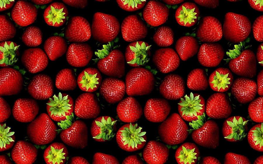 A Black Background With Many Strawberries Wallpaper