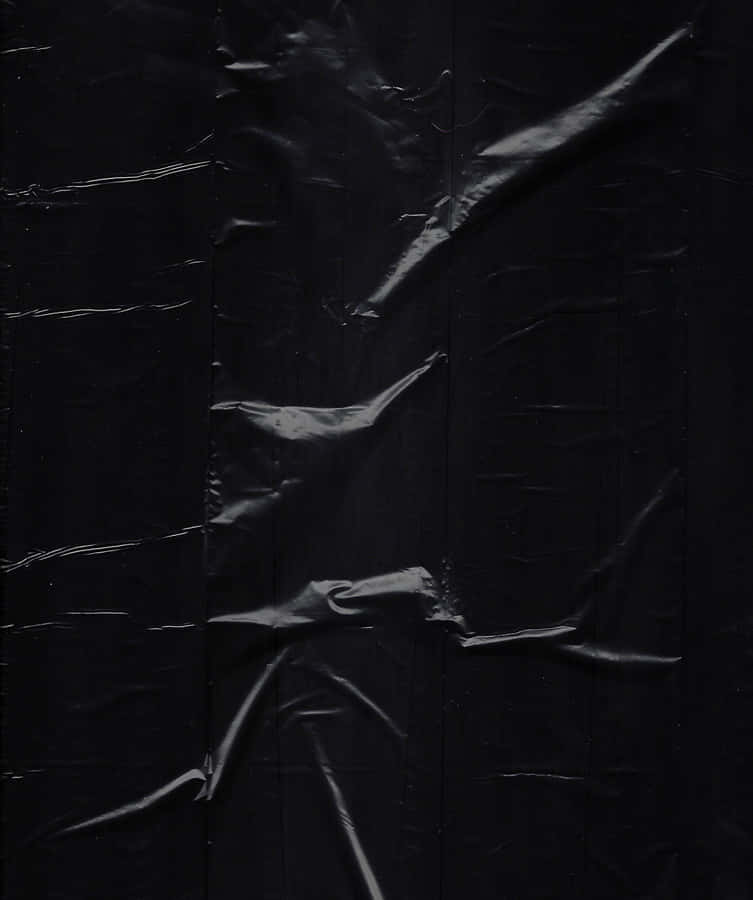 A Black Plastic Bag With A Hole In It Wallpaper