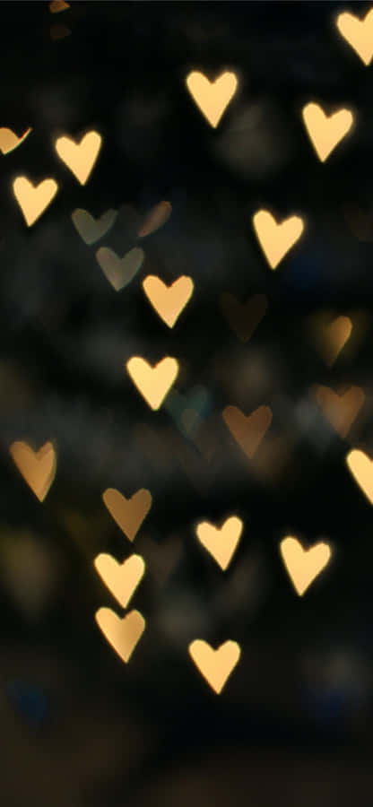 A Blurry Image Of Many Hearts In The Dark Wallpaper