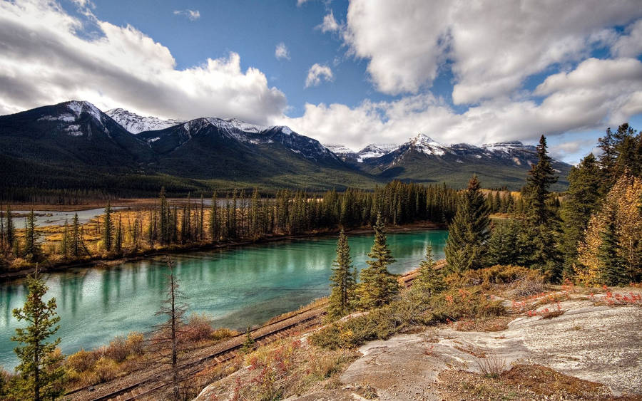 A Breathtaking View Of The Snow-capped Mountains In Banff National Park - Wallpaper