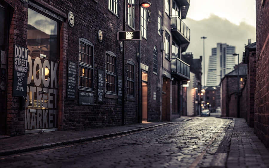 A Brick Street With A Sign Wallpaper