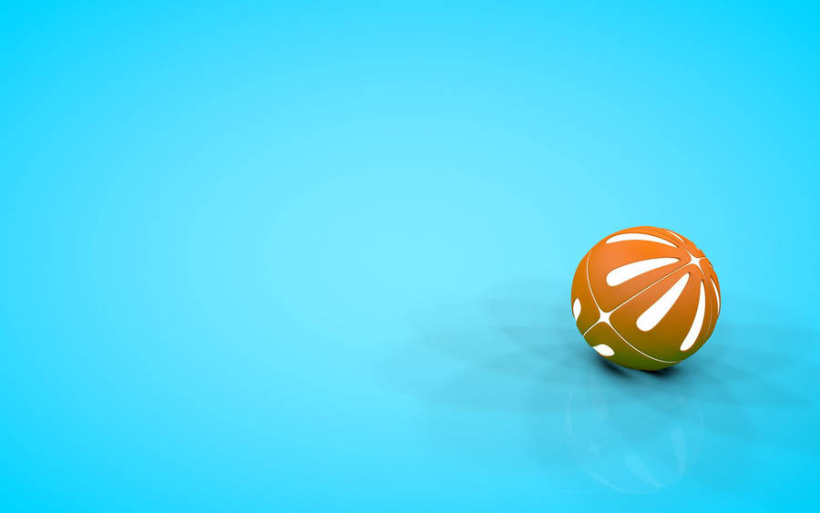 A Bright Orange Beach Ball Floating Against A Pristine Blue Sky Wallpaper