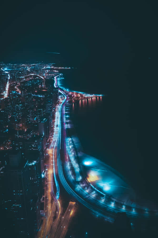 A City At Night With A Blue Sky And Traffic Wallpaper