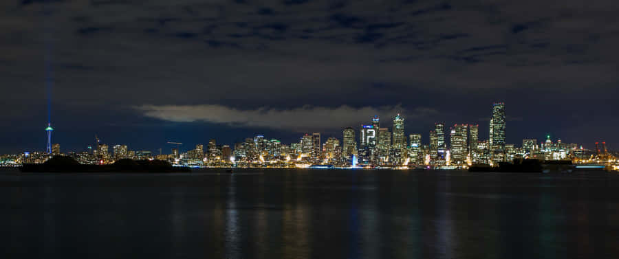 A City Skyline At Night Wallpaper