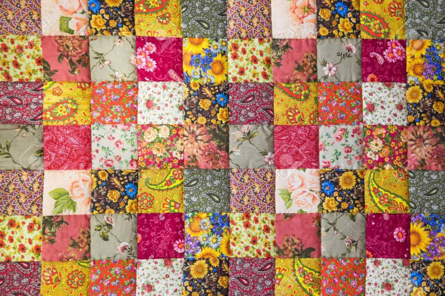 A Colorful Quilt With A Floral Pattern Wallpaper