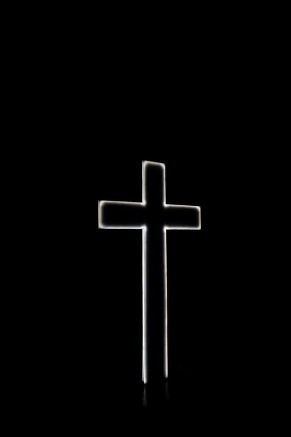 A Cross Is Lit Up In The Dark Wallpaper