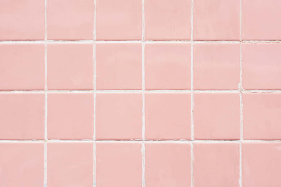 A Delicate, Pastel Pink Laptop Sits Atop A Marble Desktop. Wallpaper